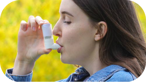 Girl using inhaler for allergy - asthma relief.