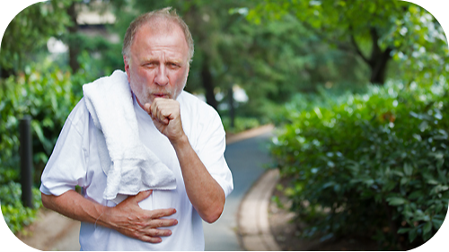 Elderly man holding his chest and coughing.